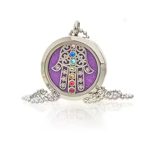 Close-up of 30mm Hamsa Chakra aromatherapy necklace UK with detailed pendant on chain against white background