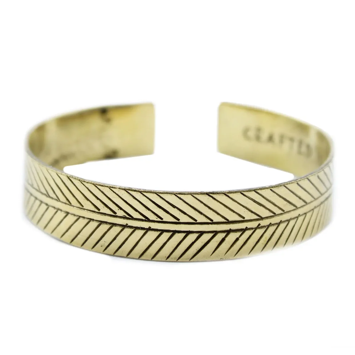 Wide tribal bracelet made of brass featuring a Tibetan design with intricate leaf patterns