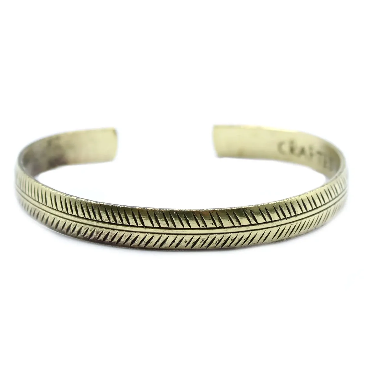 Slim tribal bracelet made of brass featuring a slender design with tribal leaf patterns