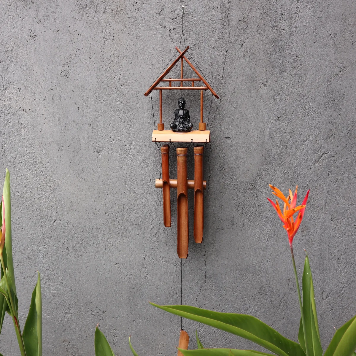 Black Buddha natural finish windchime with six bamboo tubes hanging vertically against a white background