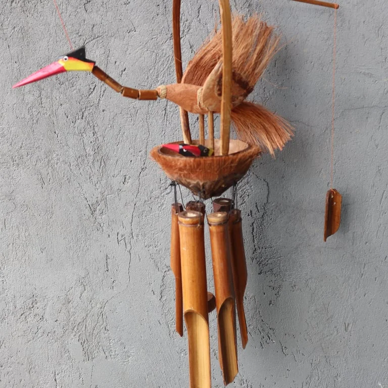 Bamboo windchime with natural finish featuring mother and chicks design hanging outdoors