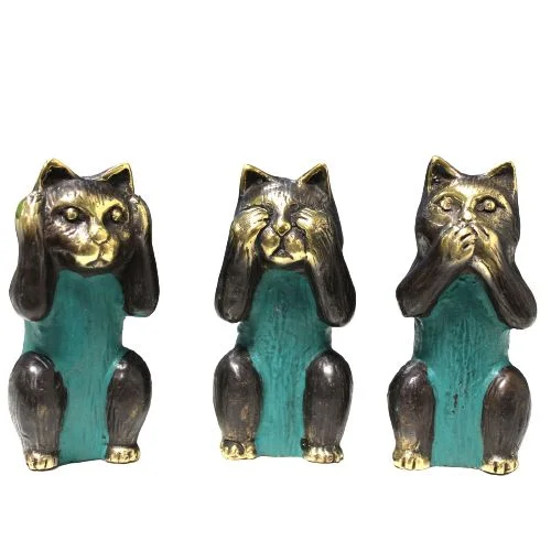 Set of three brass cat ornaments showing see no evil, hear no evil, speak no evil poses on white background