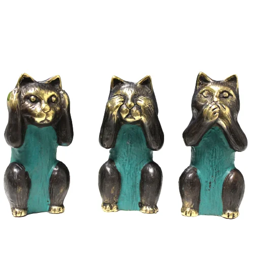 Second brass cat figurine from set of three showing Hear No Evil pose with paws covering ears on white background