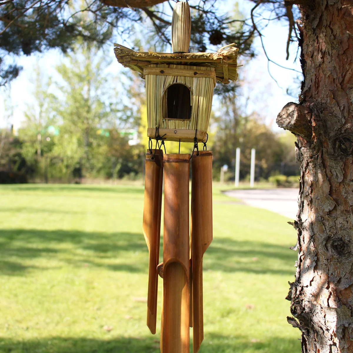 Square seagrass bird box with chimes, measuring 49x15cm, natural woven texture and hanging loop
