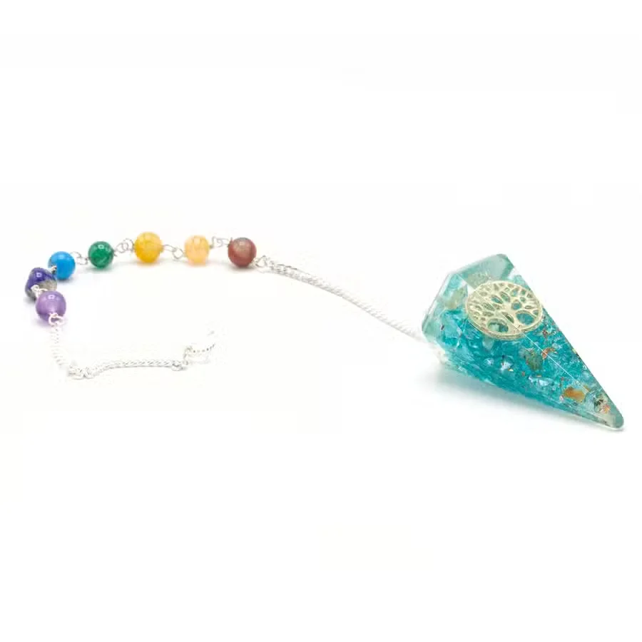 Orgonite pendulum decor featuring a Tree of Life design with chakra power elements on a white background