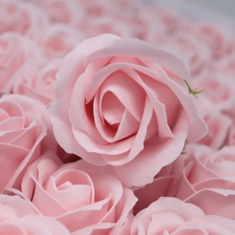 Pink medium rose craft soap flowers on white background