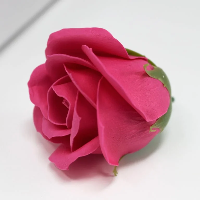Medium rose-shaped craft soap flower in rose colour, with gentle petals and textured detail.