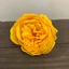Yellow craft soap flower resembling a large peony, showing detailed petals and soft curved shape.