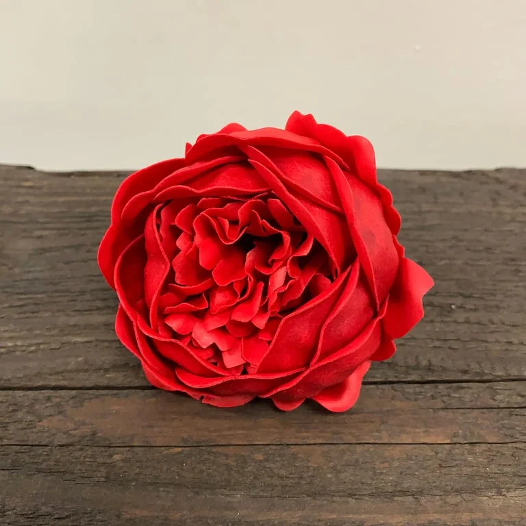Red craft soap flower shaped like an extra large peony.