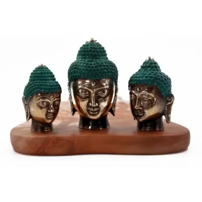 Three assorted size Buddha heads in a set, varying in size and design, displayed on a plain background
