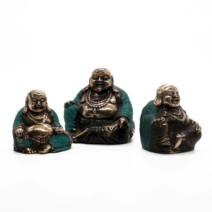 Set of three decorative Buddha statues in assorted sizes with happy expressions arranged on a white background