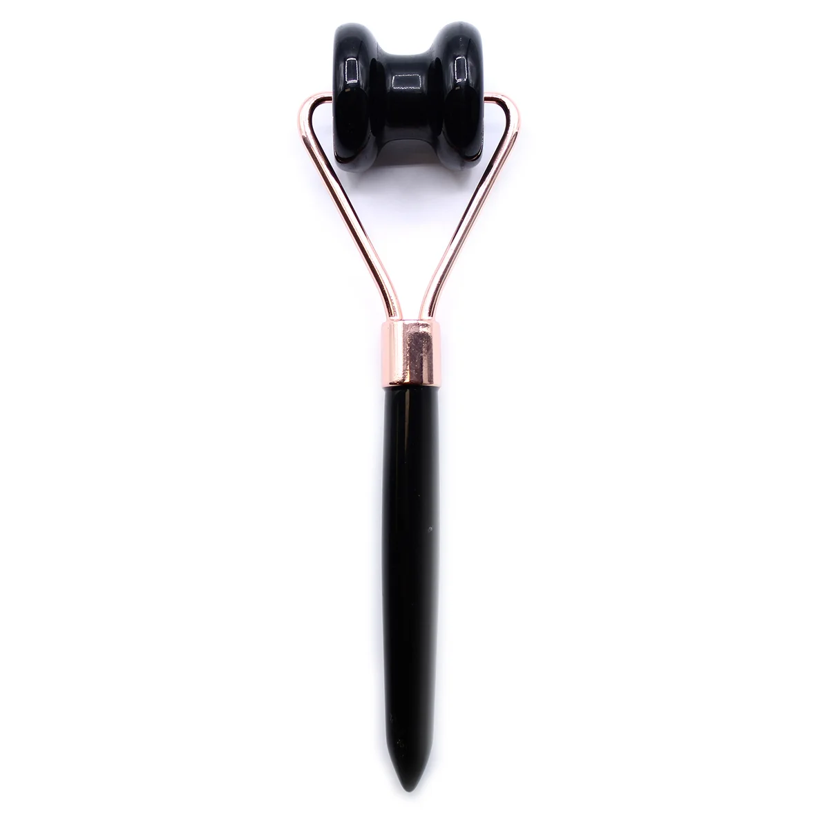 Black obsidian gemstone jawline roller lying flat, showing smooth polished surface, jawline massage tool for facial care
