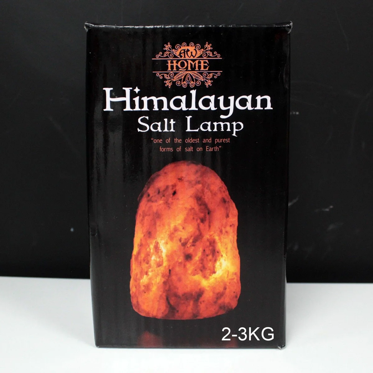 Natural salt lamp on a stand, warm amber glow, rough surface, weighs about 2‑3kg.