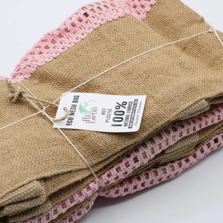 Rose‑coloured jute cotton bag, folded to display soft texture, simple pure jute cotton bag design.