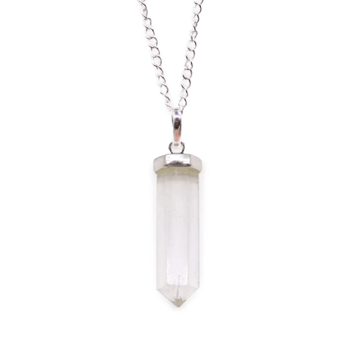 Rock quartz pendant with classic pointed gemstone on a silver chain necklace against white background