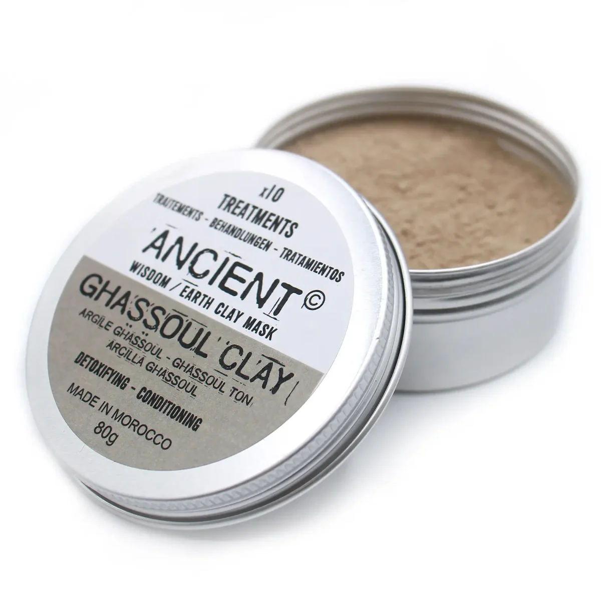 Small 80g jar of natural body clay Ghassoul Clay with clay powder visible beside the container on a white background