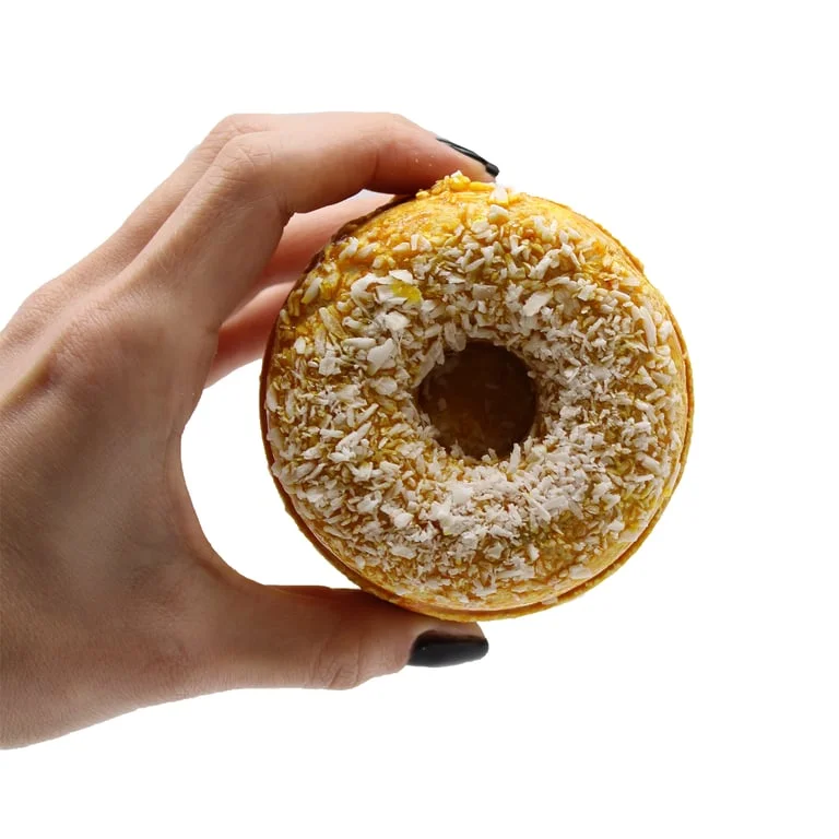 Cinnamon vanilla bath bombs shaped like donuts, displayed on a plain background