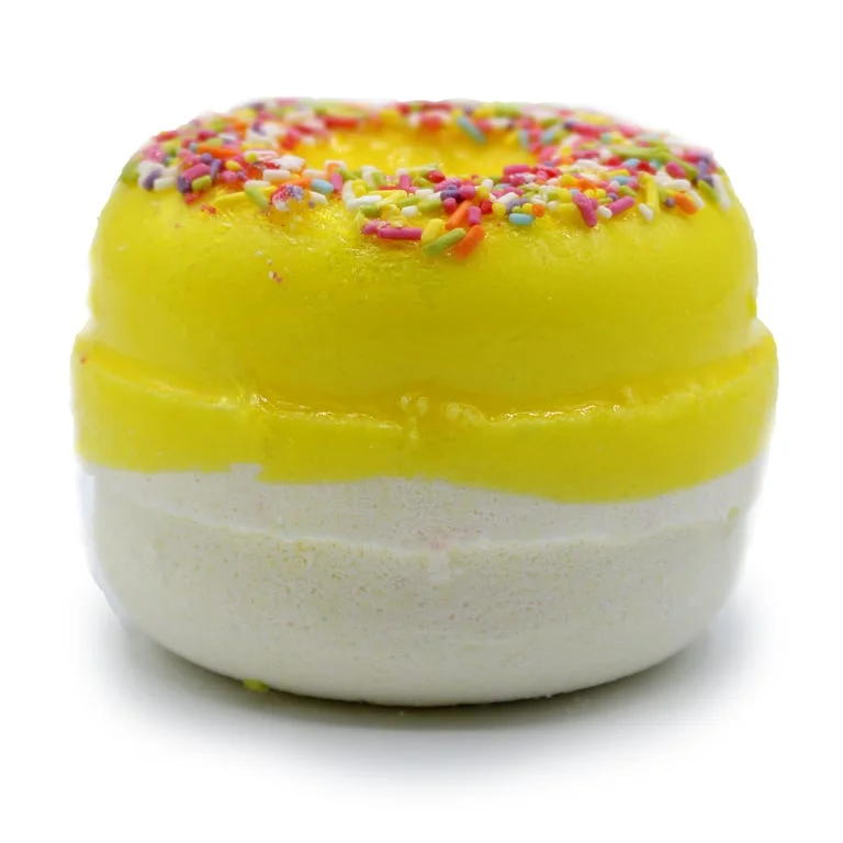 Delicious lemon meringue bath donut on a white ceramic plate, with frosted yellow glaze and airy texture, a sweet bath treat.