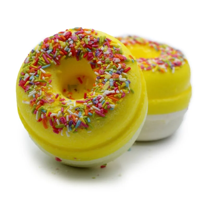 Fresh lemon‑meringue shaped bath donuts displayed in a bright setting, example of bath donuts UK