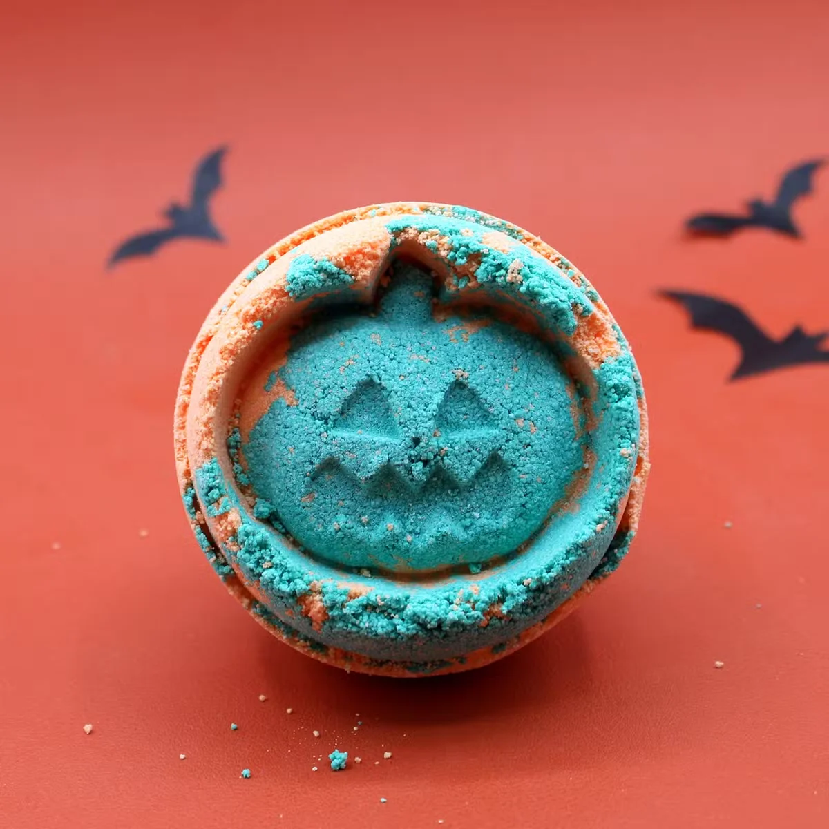 Round Fennel & Orange Halloween bath bomb with orange and green swirls, ideal Halloween bath gift for festive relaxation