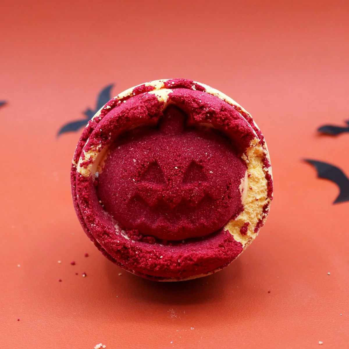 Round green Aniseed Halloween bath bomb with festive Halloween-themed packaging on a white background
