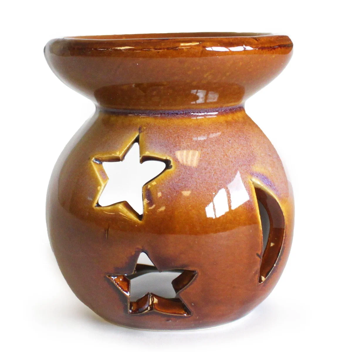 Ceramic moon star oil burner with cut-out shapes for holding essential oils and tealight candle below