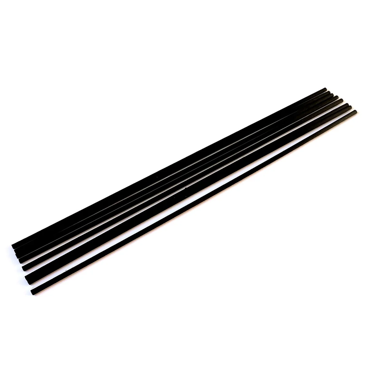 Black reed diffuser with slender 25cm x 3mm fibre black reeds in a minimalist style