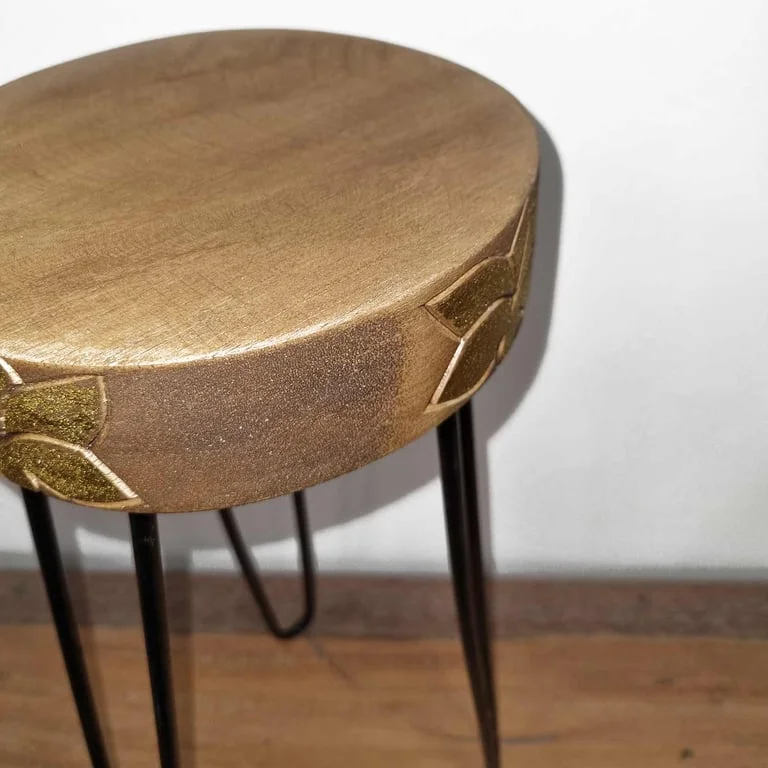 Albasia wood plant stand showing natural wood surface with subtle gold accents on its frame
