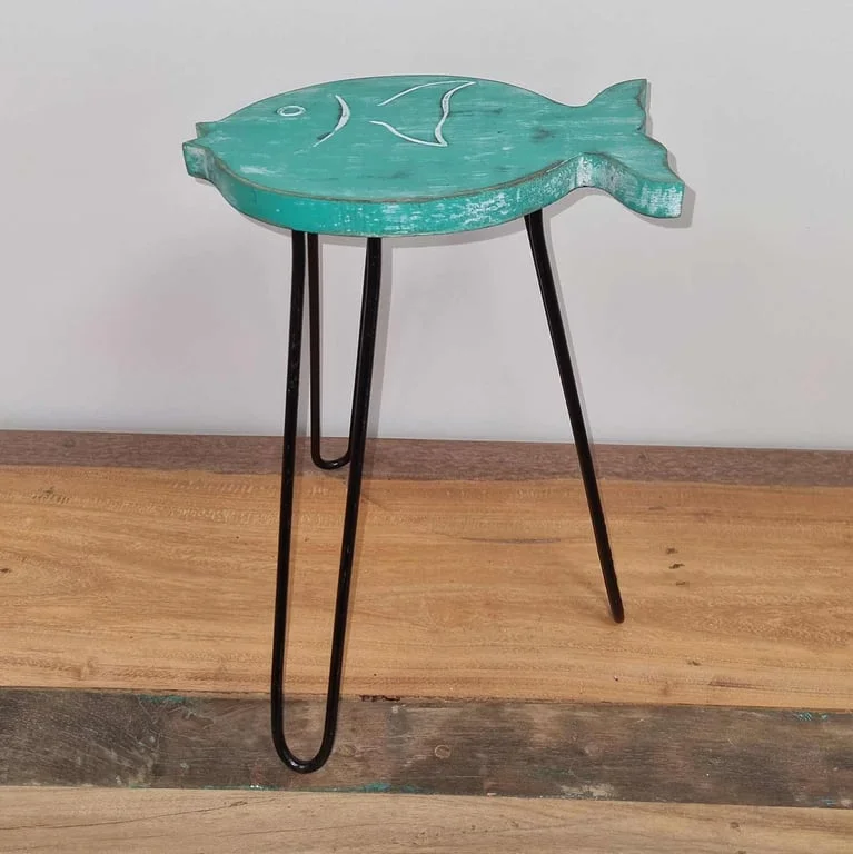 Albasia wood fish stand in turquoise color displayed upright on a wooden surface