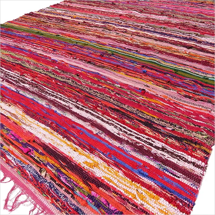 Red luxury rag rug measuring 150 x 90cm displayed flat on a white background