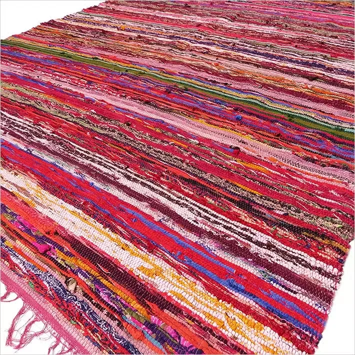 Red luxury door mat rag rug measuring 150 x 90cm with a textured woven design on a wooden floor