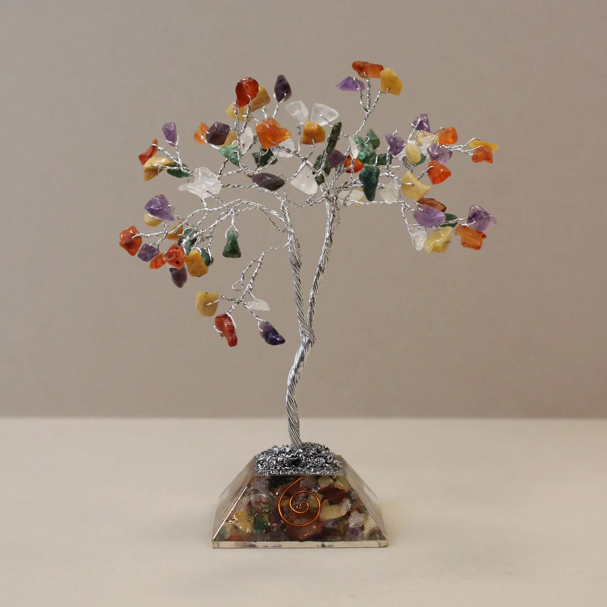 Multi-coloured gemstone tree ornament with 80 stones and a decorative organite base on display