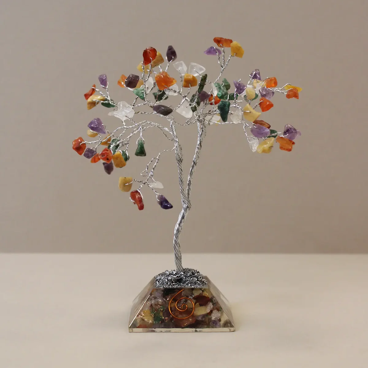 Multi-colored gemstone tree with organite base tree featuring 80 polished stones on display