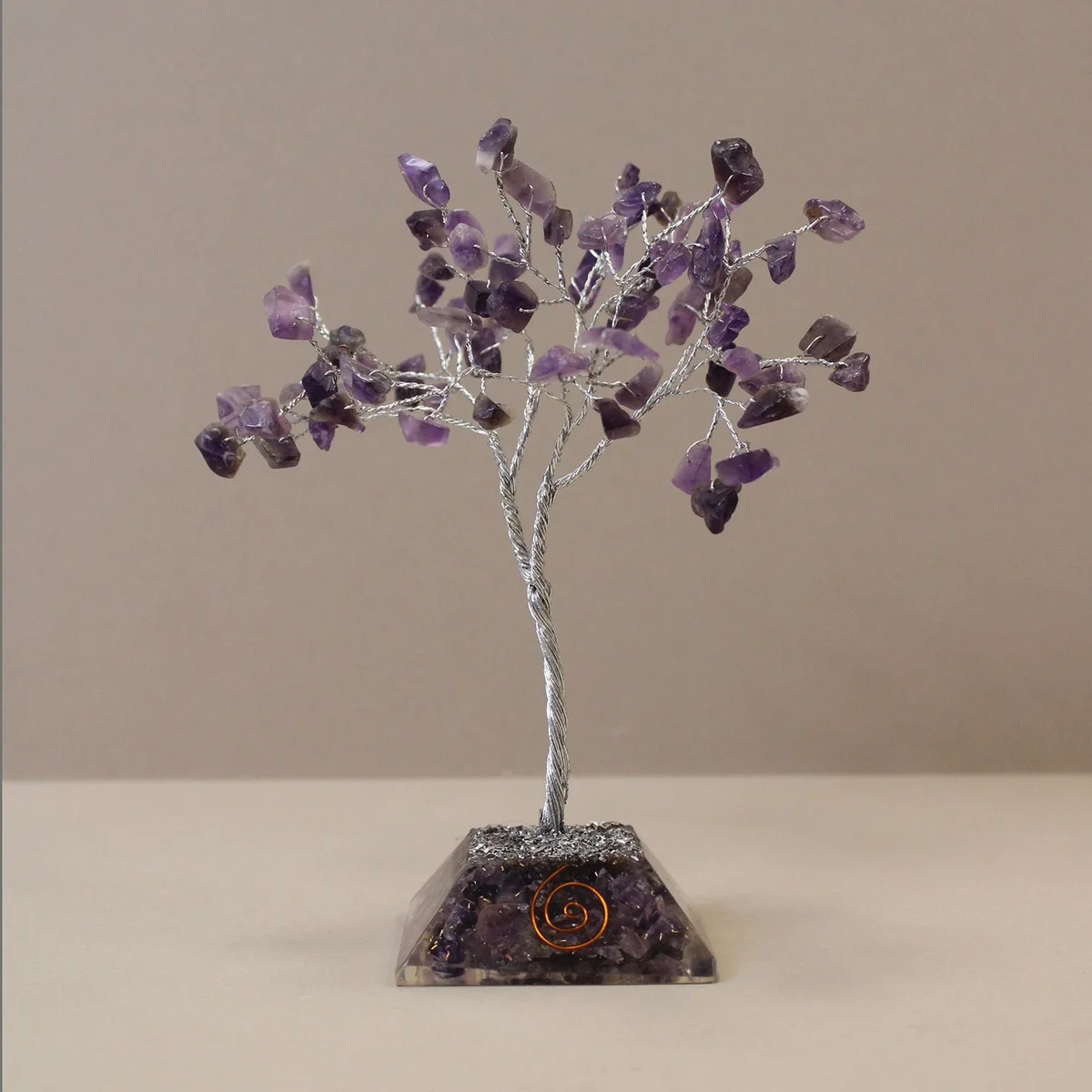 Amethyst gemstone tree with 80 stones on an organite base displayed on a white background