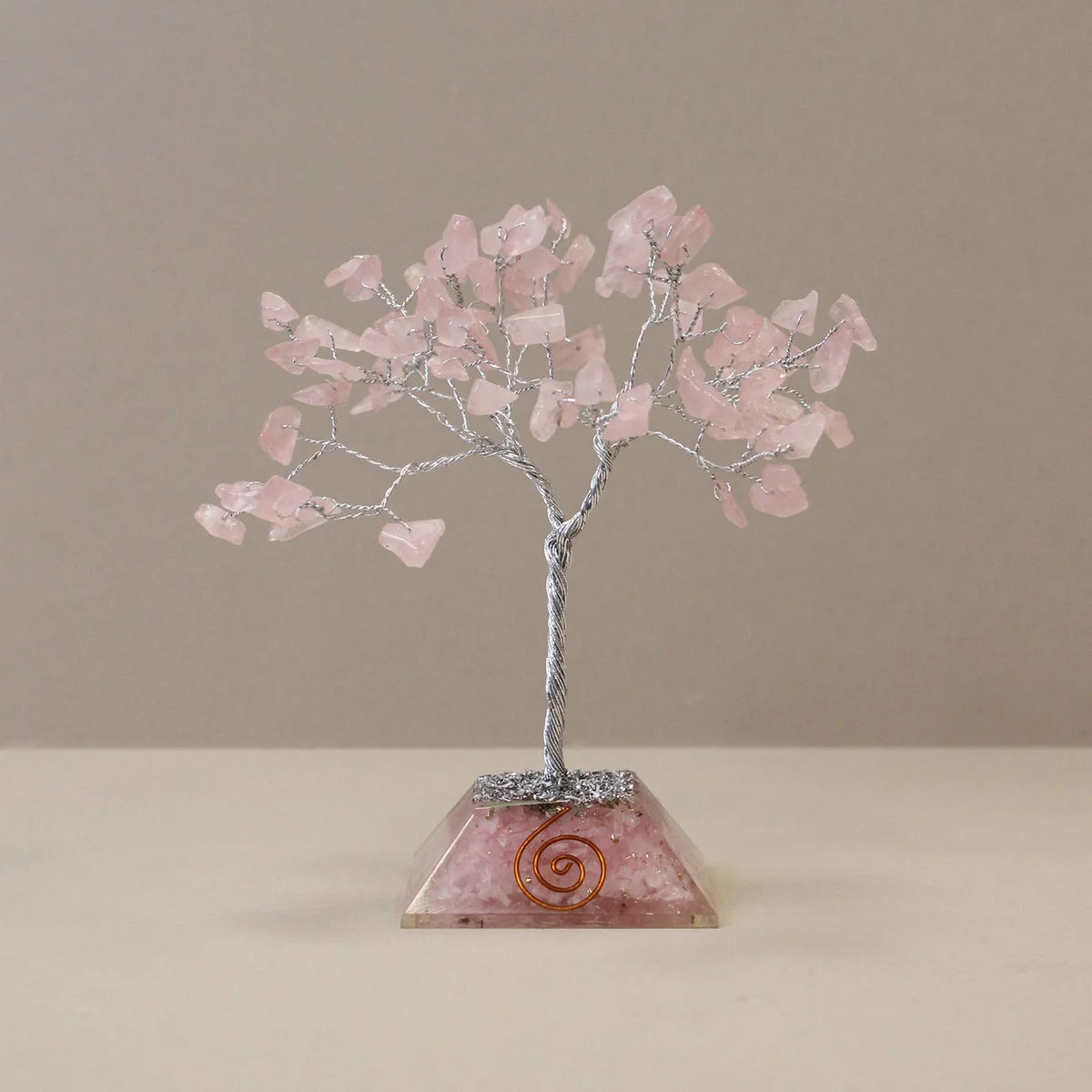 Rose quartz gemstone tree with 80 stones and organite base displayed on white background