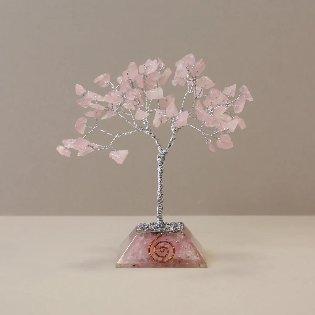 Gemstone tree ornament with 80 rose quartz stones on an organite base displayed on a white background