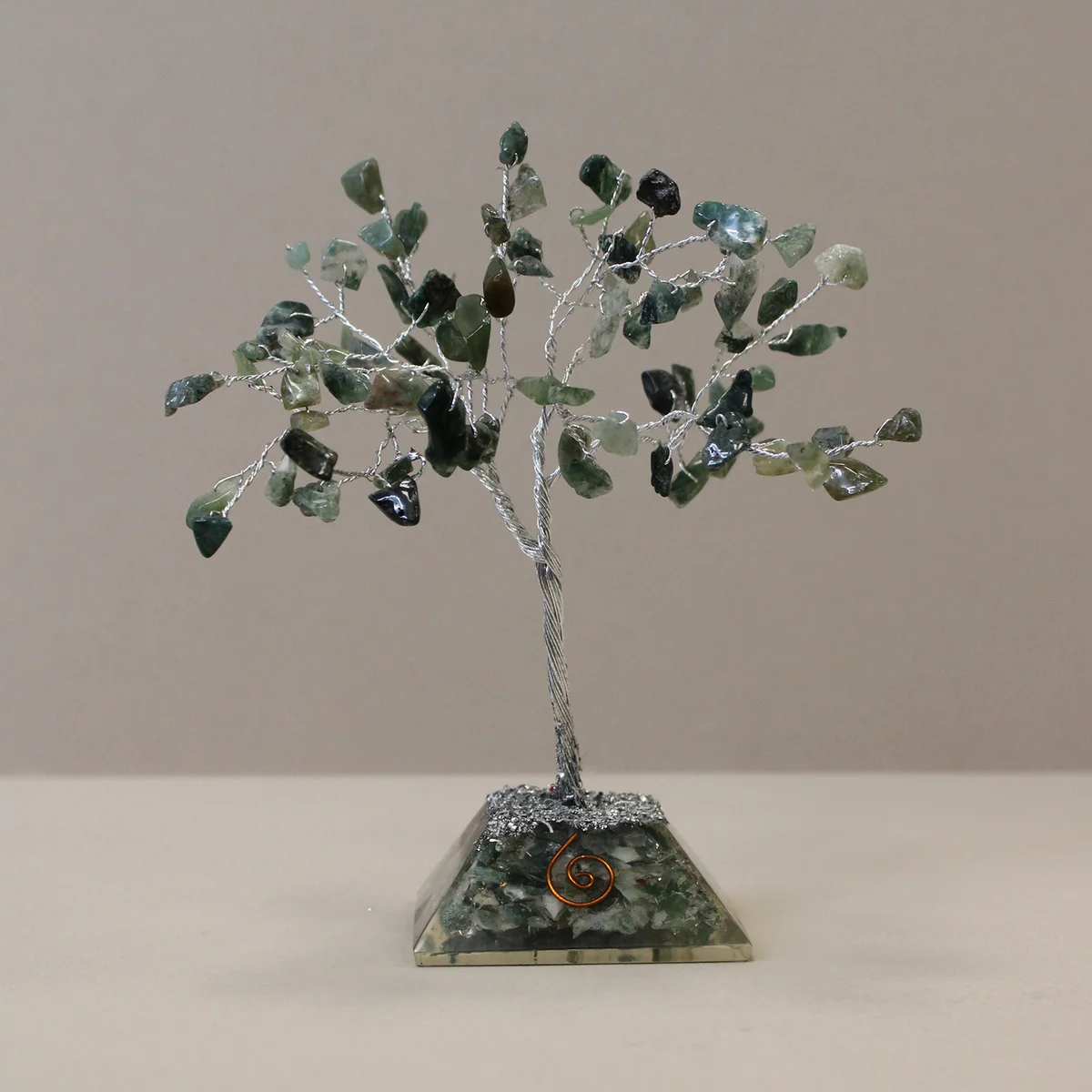 Gemstone tree with 80 moss agate stones on a decorative organite base decoration against white background