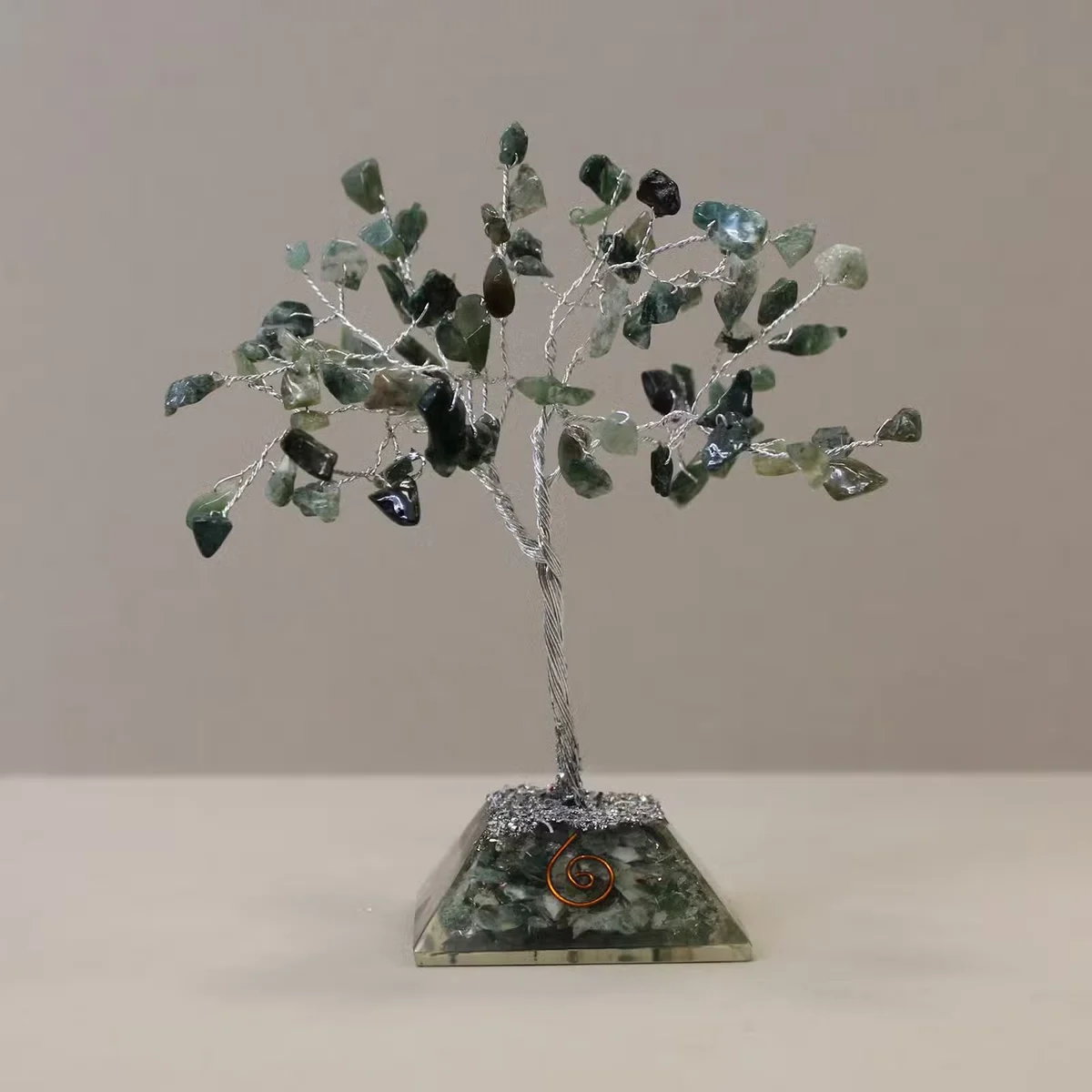 80 stone gemstone tree with green moss agate leaves and a decorative organite base on a white background
