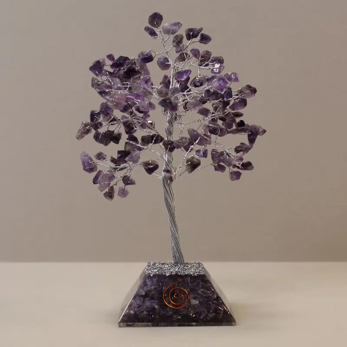 Decorative gemstone tree with 160 amethyst stones on an organite base, shown from a side angle on white background