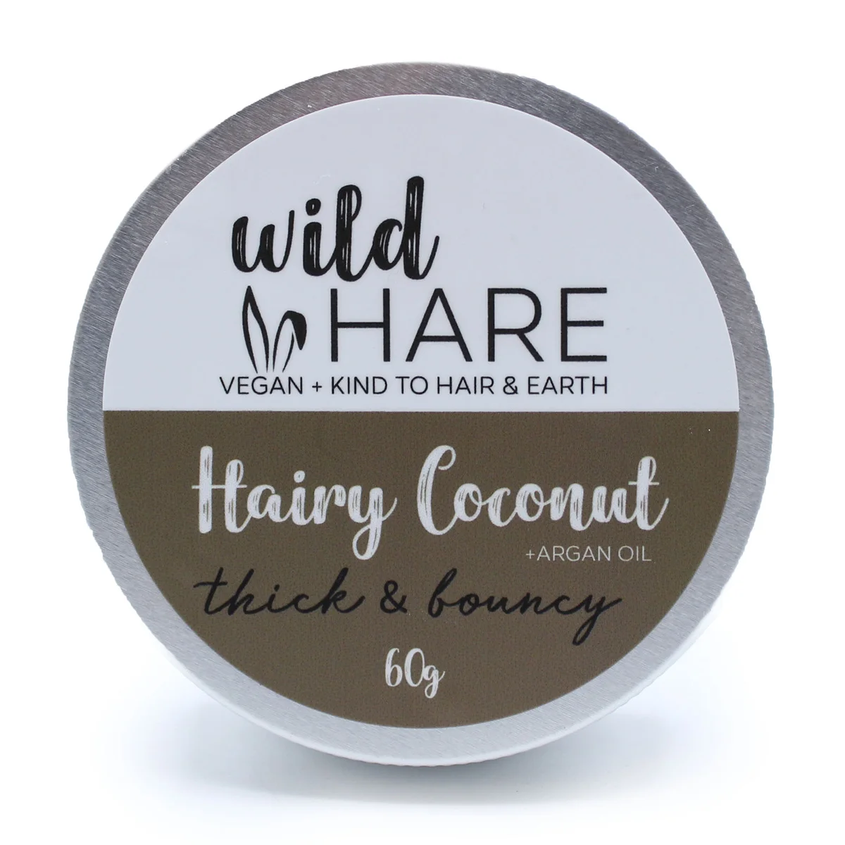 Wild Hare Hairy Coconut natural solid shampoo bar 60g on white background with leaves and coconut halves