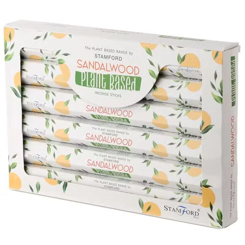 Bundle of plant based aromatic incense sticks with sandalwood scent on a plain background