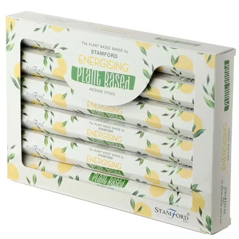 Energising plant based aromatherapy incense sticks arranged on a white background with green leaves nearby