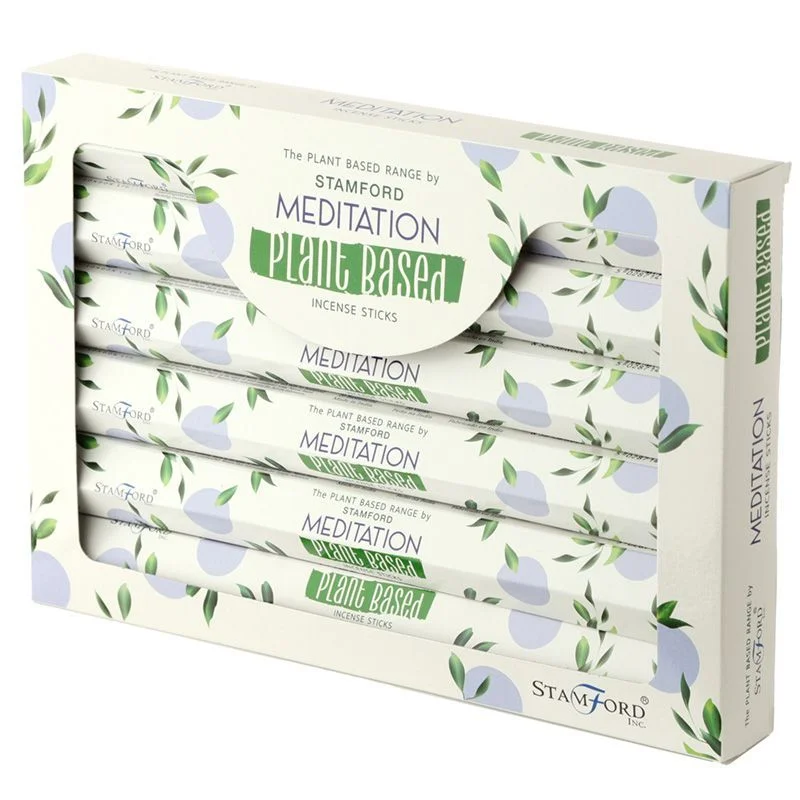 Pack of plant based incense sticks for meditation with natural wooden sticks and green packaging on white background
