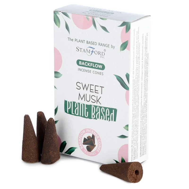 Plant based backflow incense cones in sweet musk scent arranged on a wooden holder against a white background