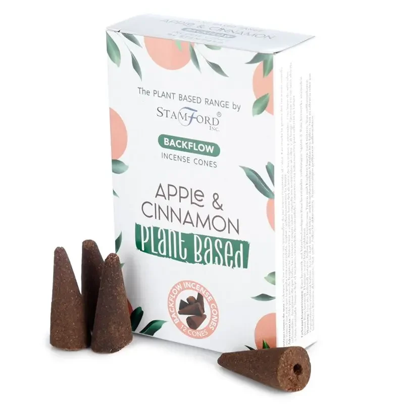 Plant based incense cones in apple and cinnamon scent arranged on a wooden surface with soft lighting