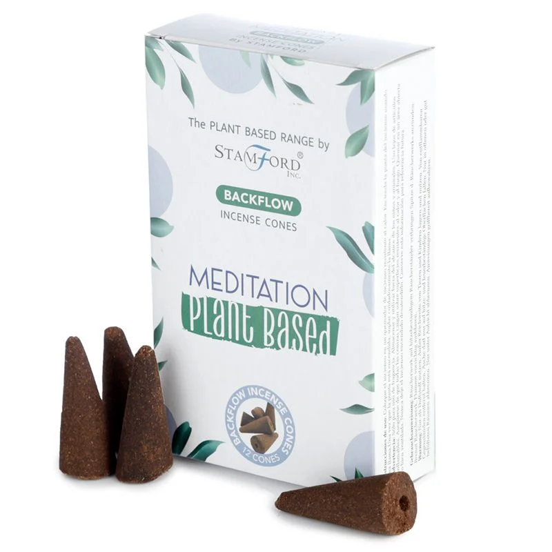 Stack of plant-based meditation incense cones arranged for backflow burning on a ceramic holder