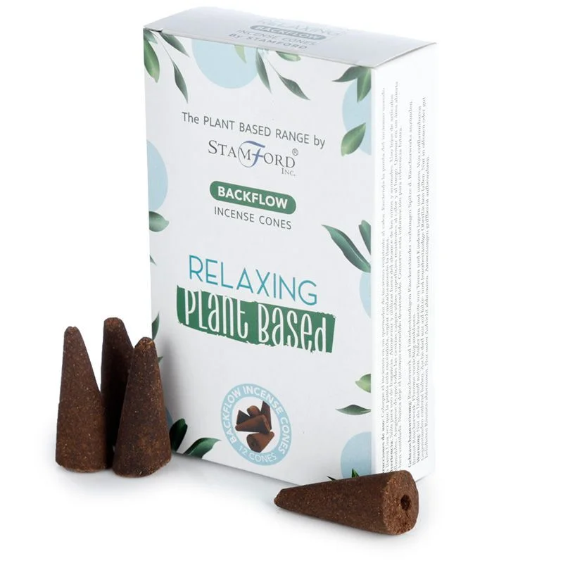 Plant based backflow incense cones arranged on a decorative holder emitting smoke for relaxation purposes