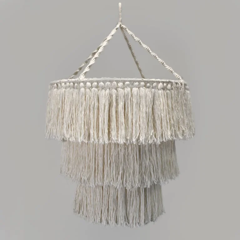 Soft natural macrame chandelier hanging from the ceiling with natural coloured cords.