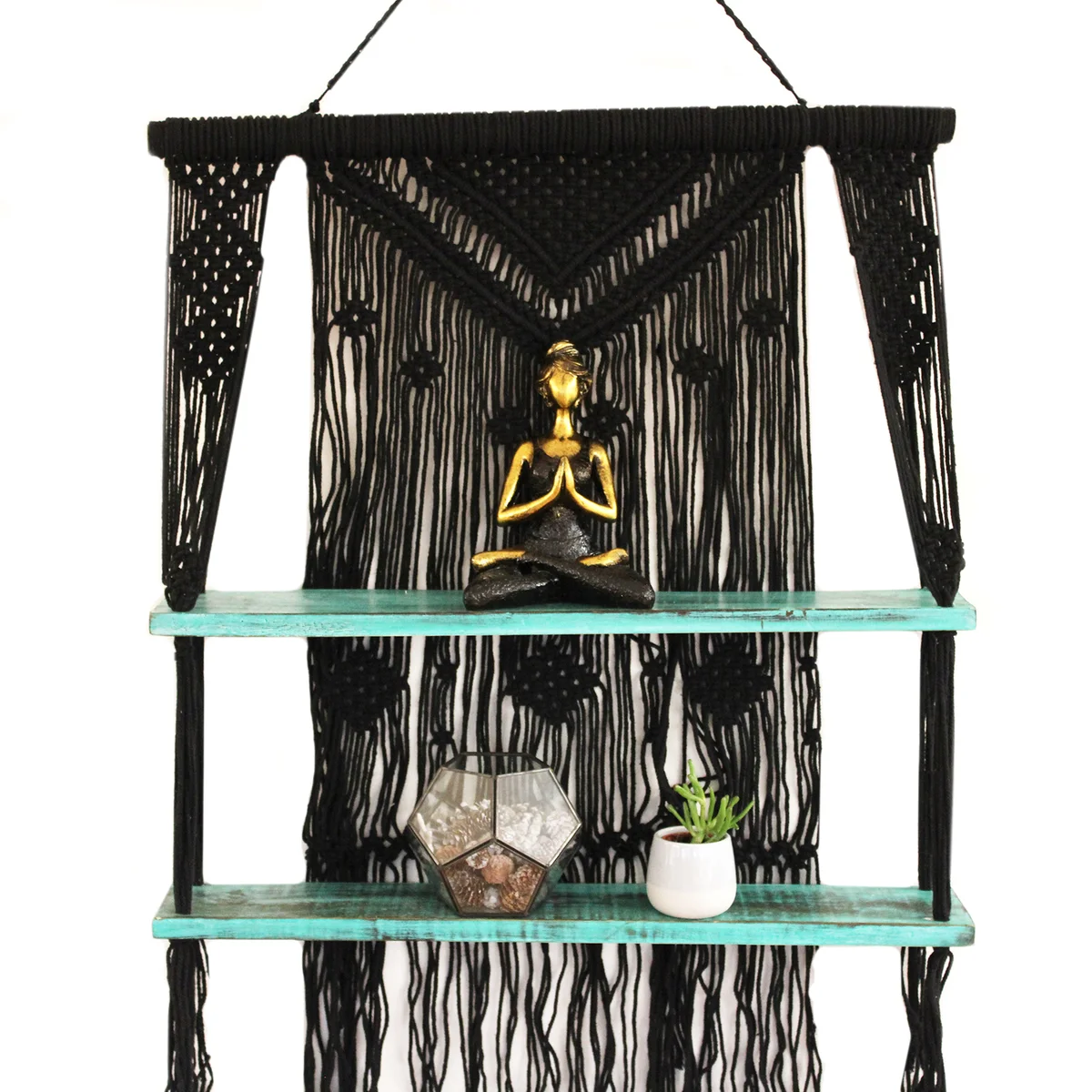 Black macrame hanging shelves in turquoise, suspended and displaying decorative items against a neutral background