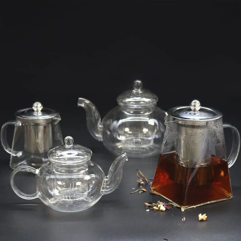 Modern 550ml glass infuser teapot with clear body and metal infuser, presented on a tabletop.